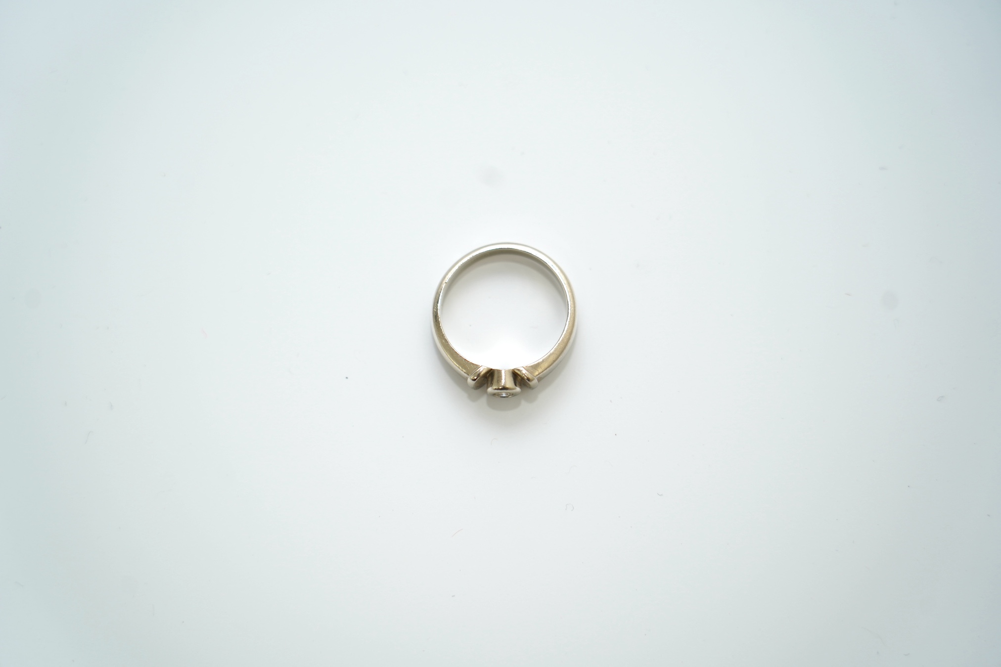 A mid to late 20th century Polish 583 standard white metal and solitaire diamond chip set ring, size N, gross weight 4.3 grams. Condition - fair